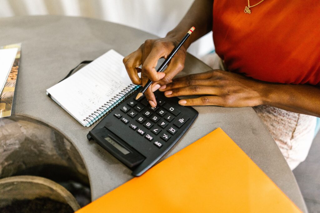 person with calculator and notepad