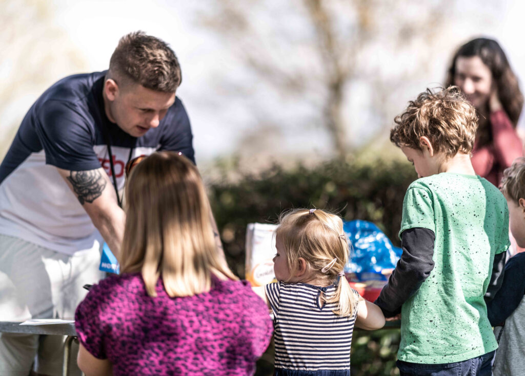 Young Adult helping children