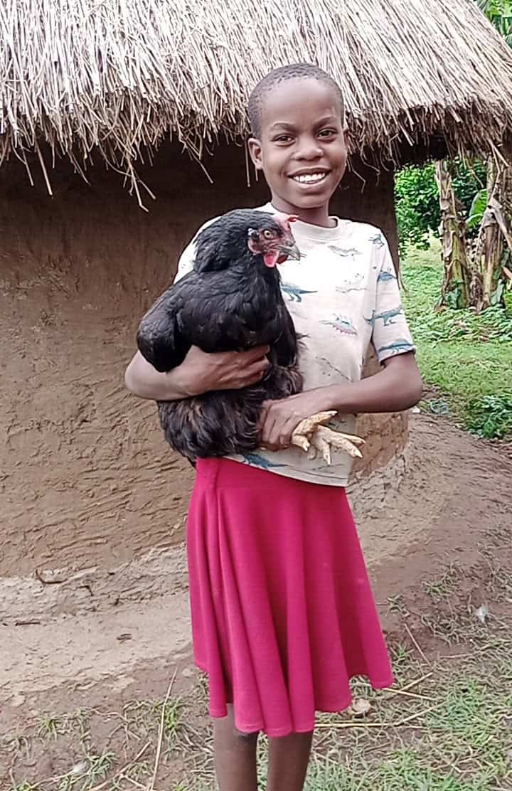 Ugandan girl holding a chicken