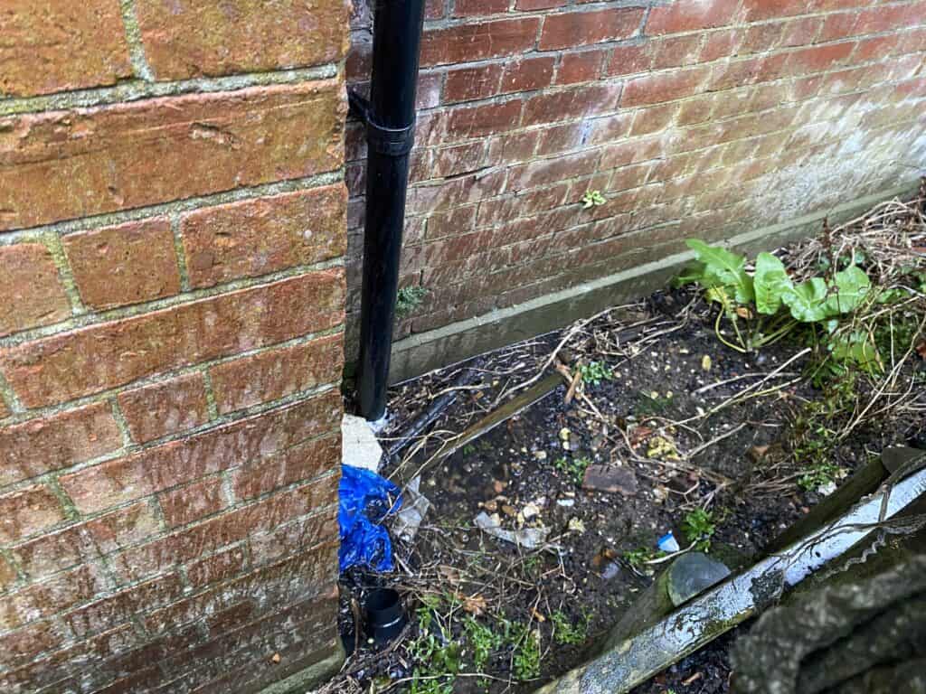Blocked drainage on west wall of hall