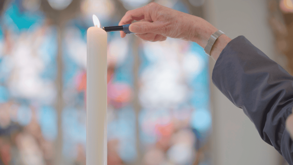Lighting a candle in a church